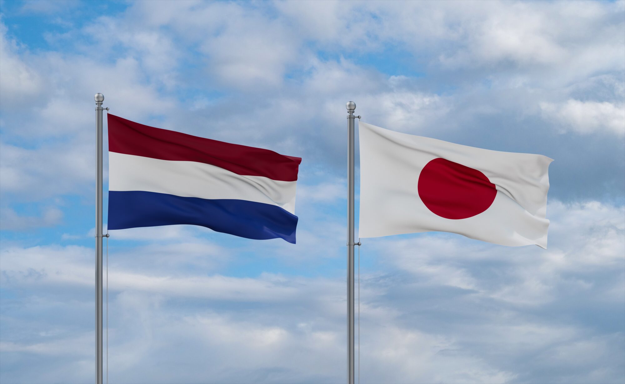 Japan,And,Netherlands,Flags,Waving,Together,On,Blue,Cloudy,Sky,
